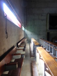 Pews, getting light from slit windows, whose sides are painted different colours