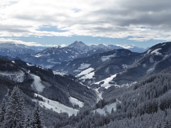 View from a ridge: hot air balloons floating over Dienten